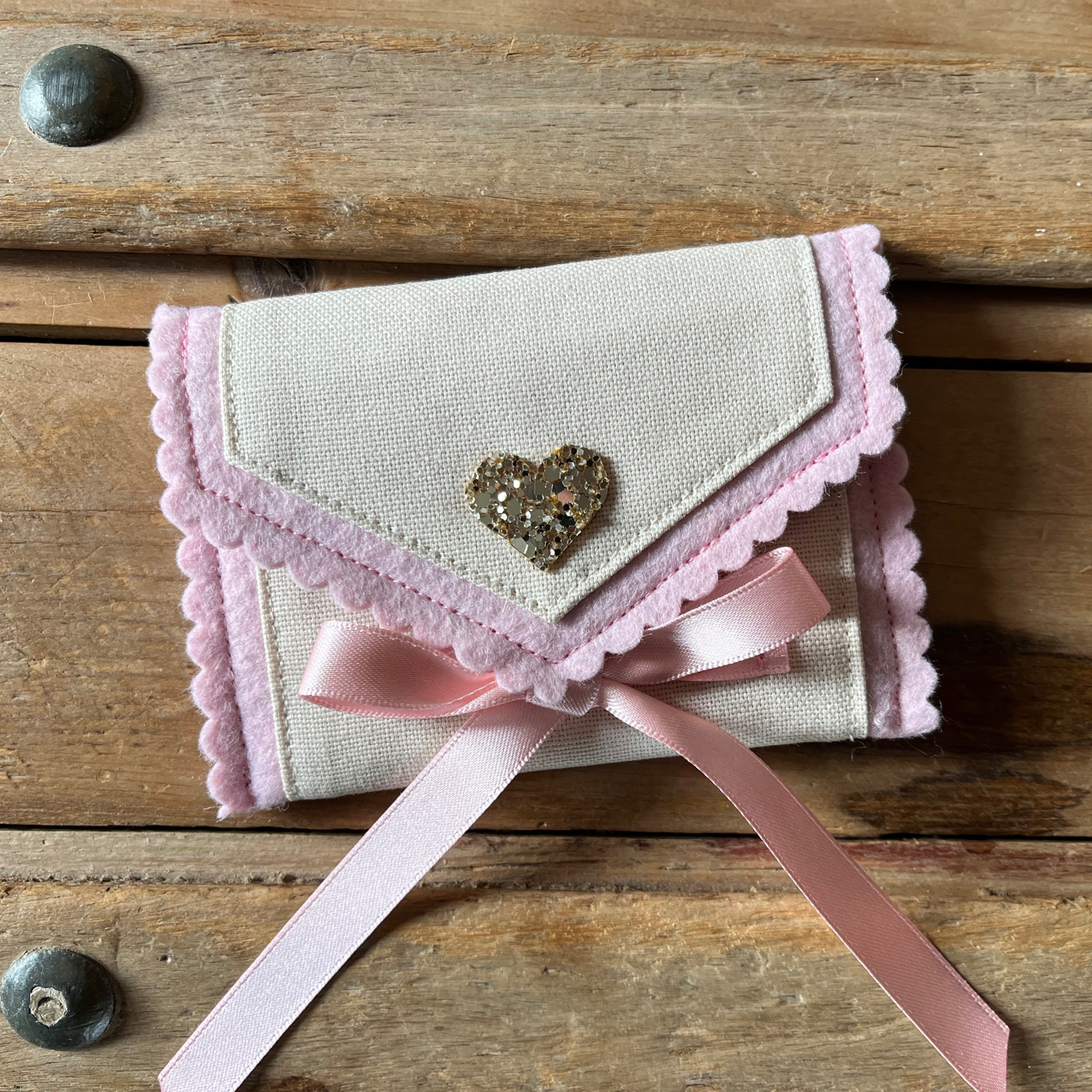 Decorative personalised tooth fairy pouch with glitter detail, ribbon fastening and scalloped edging. 