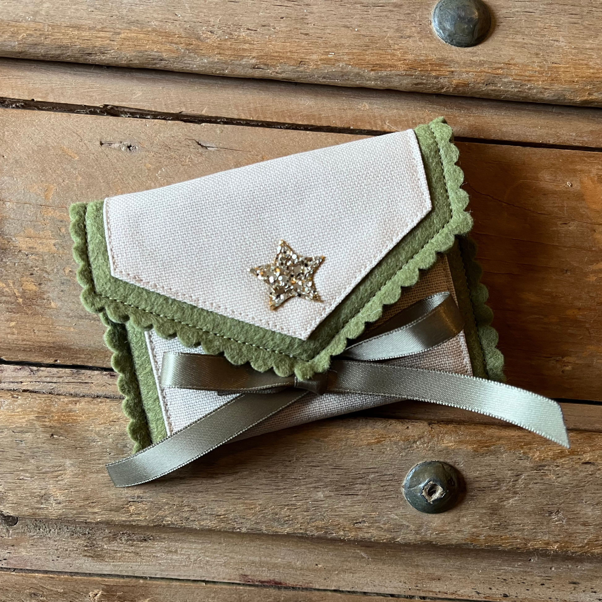 Decorative personalised tooth fairy pouch with glitter detail, ribbon fastening and scalloped edging. 