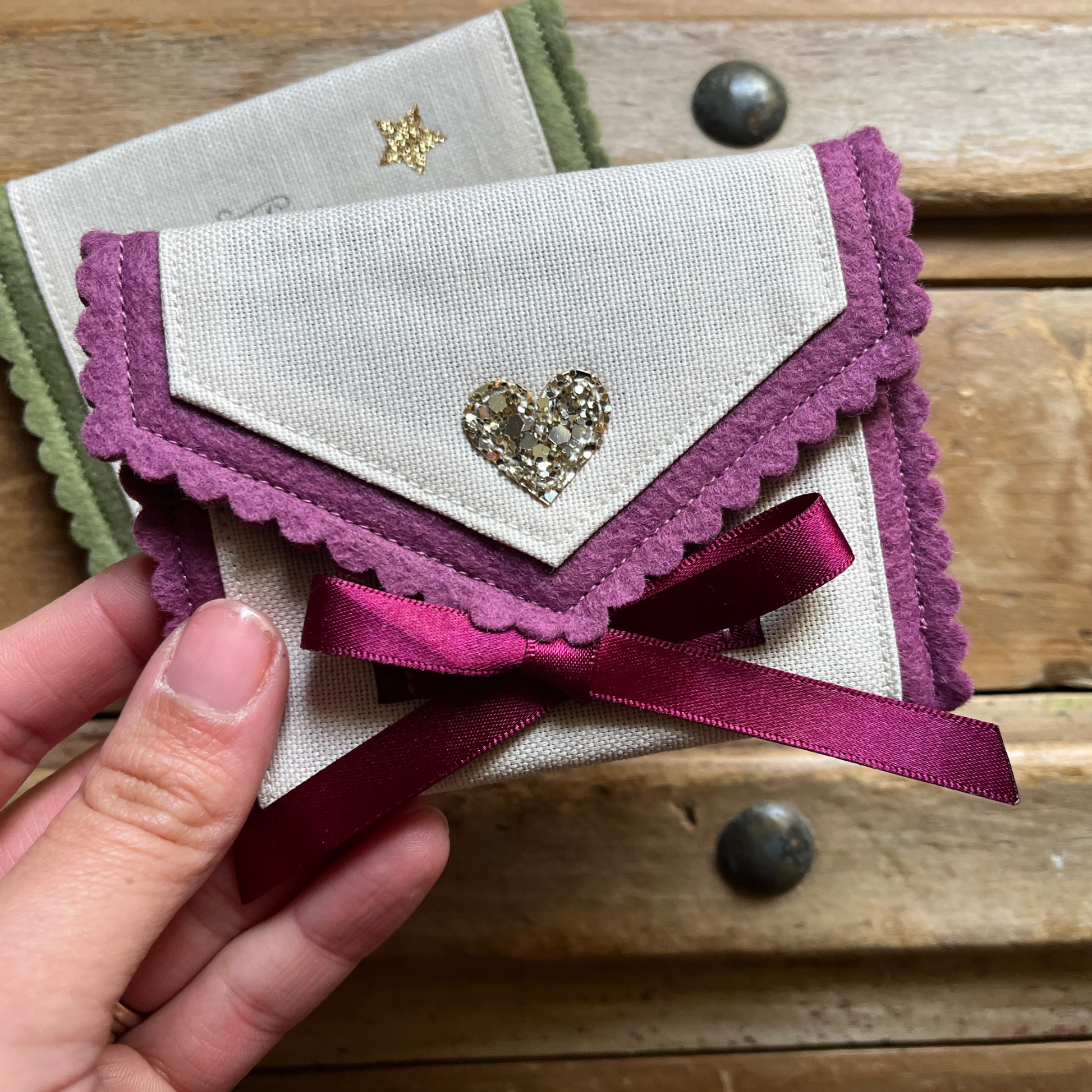 Decorative personalised tooth fairy pouch with glitter detail, ribbon fastening and scalloped edging. 