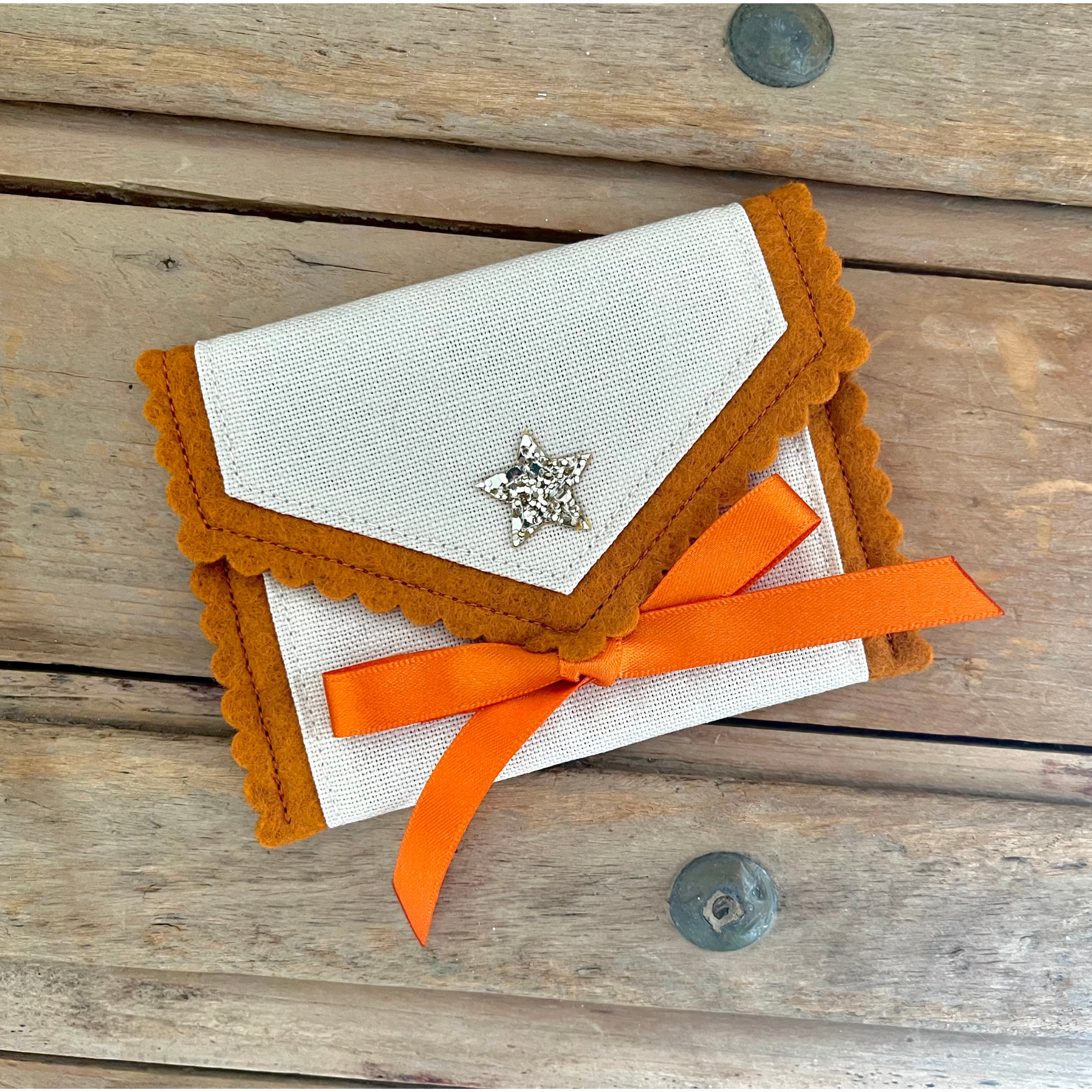 Decorative personalised tooth fairy pouch with glitter detail, ribbon fastening and scalloped edging. 