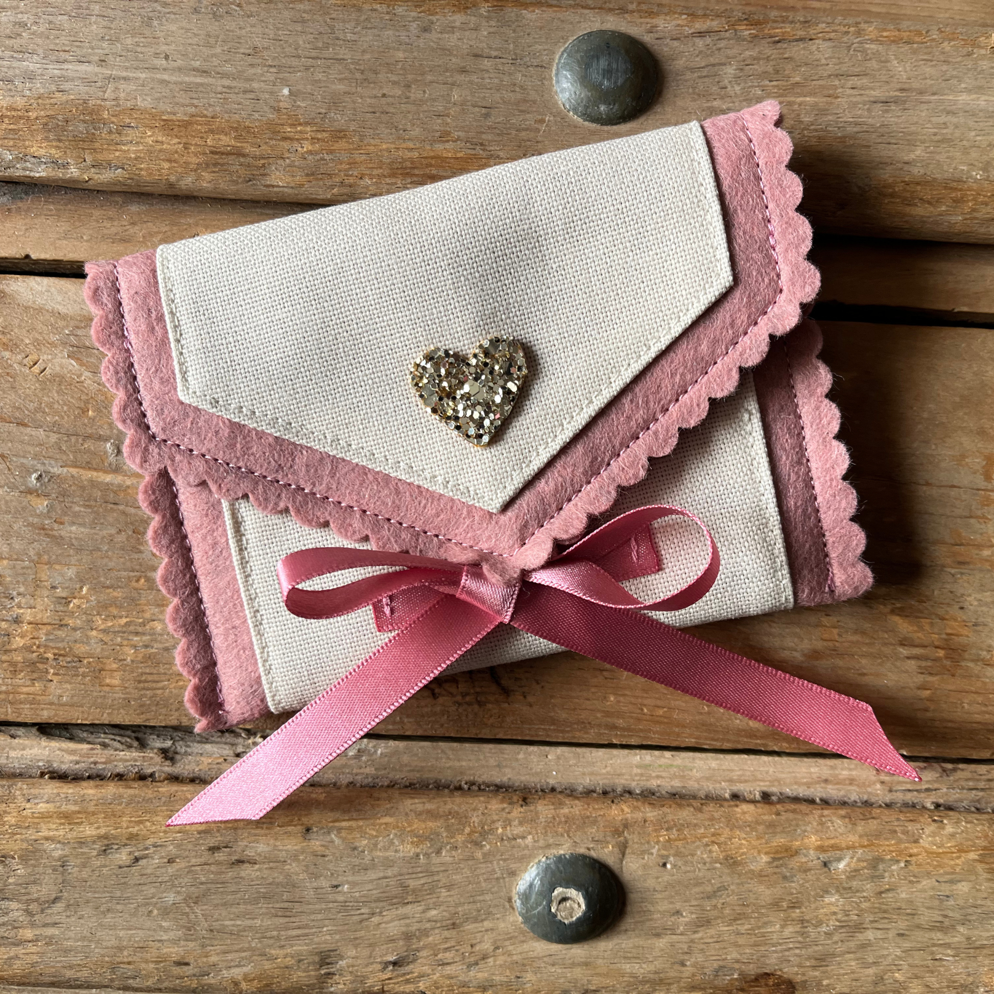 Decorative personalised tooth fairy pouch with glitter detail, ribbon fastening and scalloped edging. 