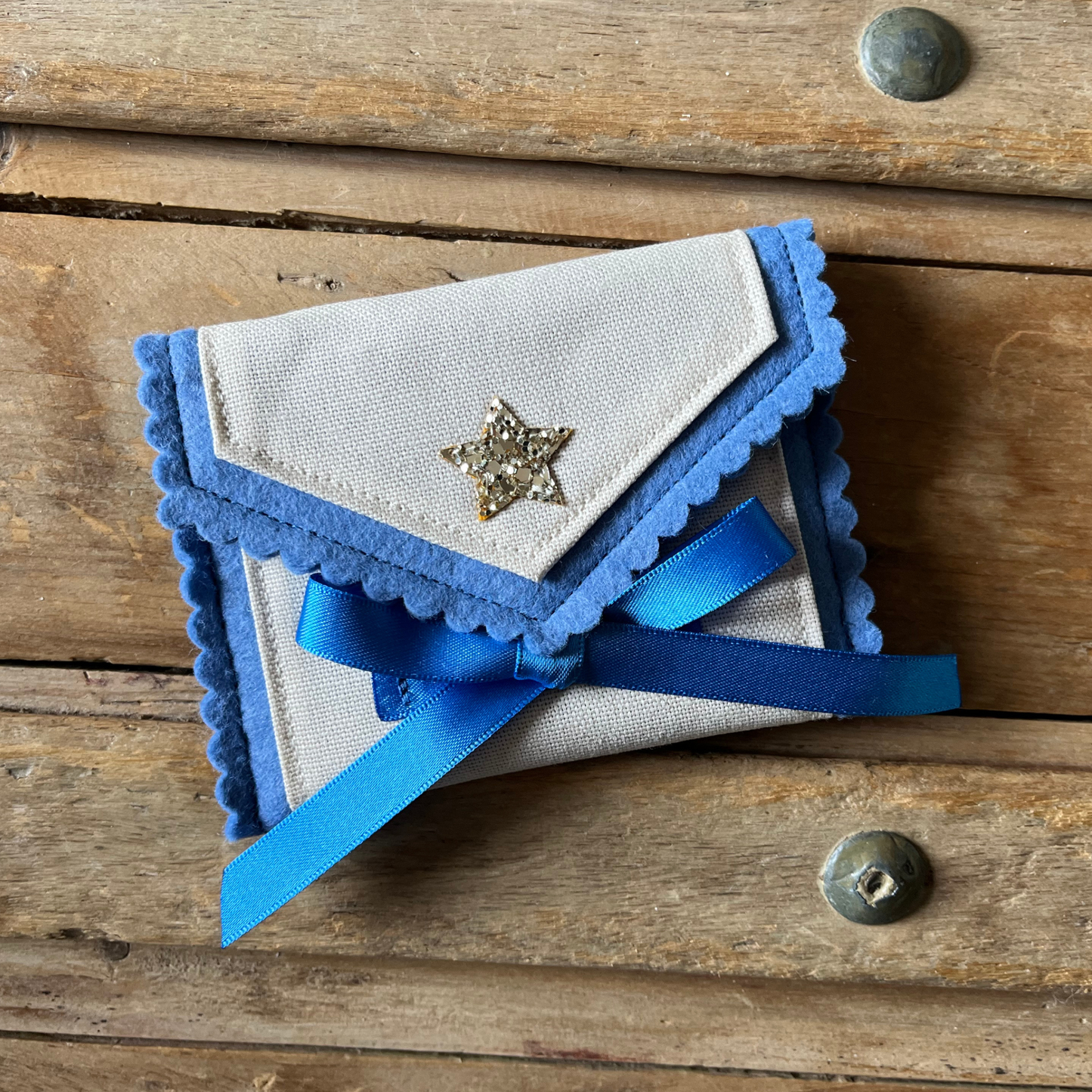 Decorative personalised tooth fairy pouch with glitter detail, ribbon fastening and scalloped edging. 
